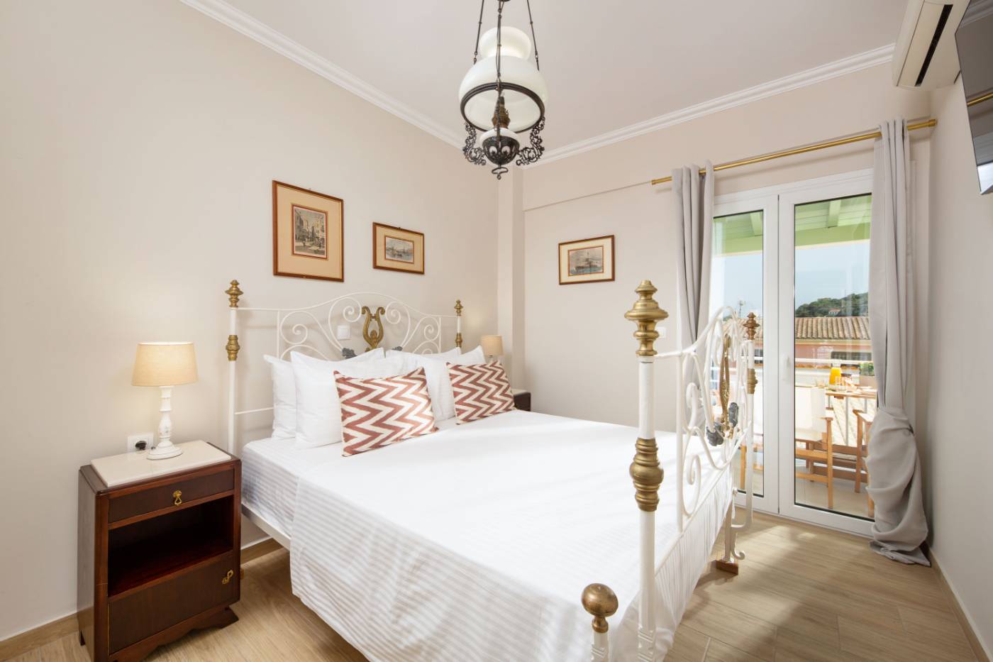 Venti di Paxos I — double bedroom with iron bed and balcony doors